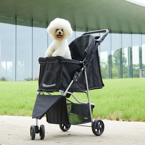 Small white dog sitting in the Loft Cruiser 3-wheel pet stroller outdoors